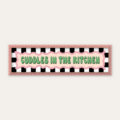Cuddles In The Kitchen panoramic print in a pink bobbin frame