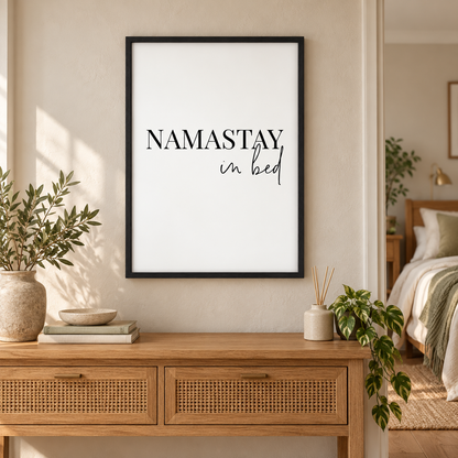 Namastay In Bed Print — wider room setting, black oak frame