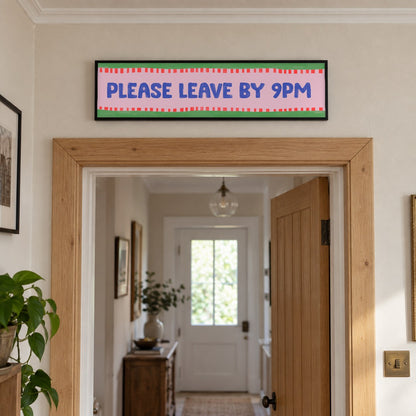 Please Leave By 9pm panoramic print in a black frame in a room setting