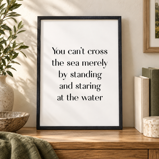 You Can't Cross The Sea Merely By Standing And Staring At The Water Print — close lifestyle view, black oak frame